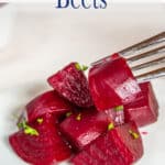 Cooked beets on a white plate.