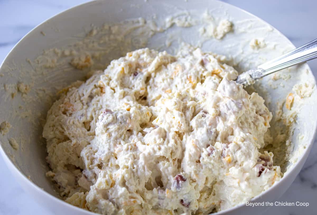 Biscuit dough in a white bowl.