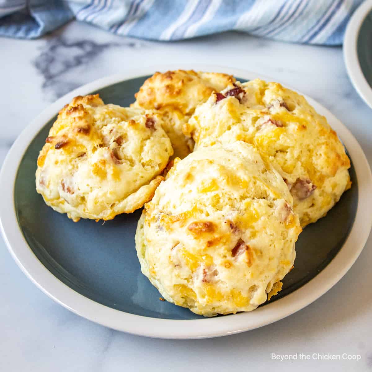 Drop biscuits with ham and cheese on a blue plate.