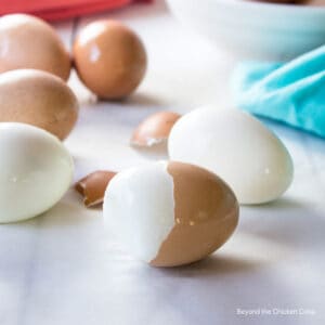 Hard boiled eggs with half the shell off.