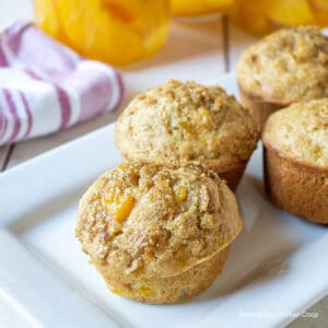 A platter filled with peach muffins.