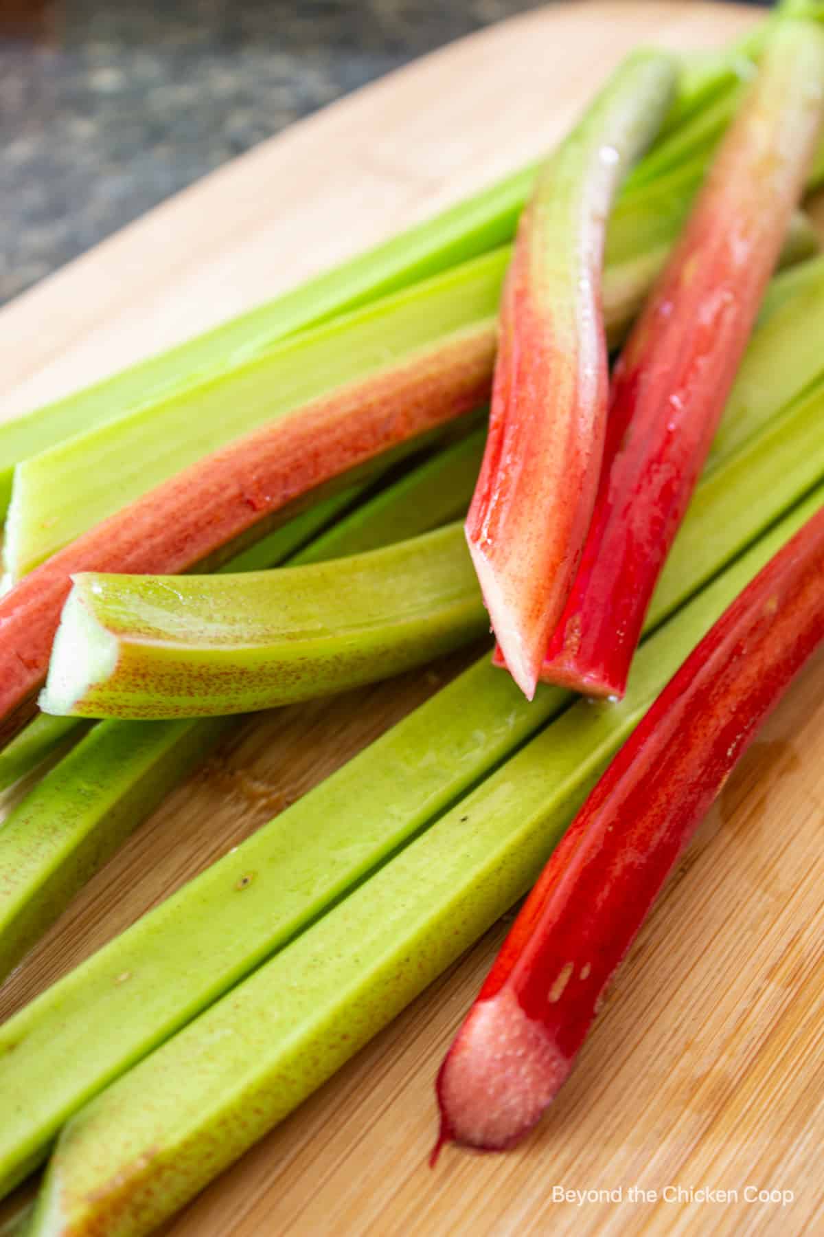 Stalks of rhubarb on a cutting board.