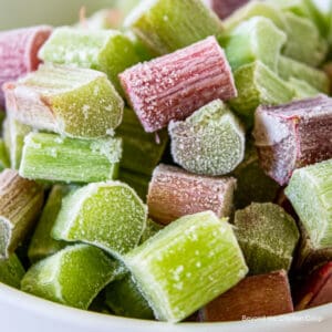 Frozen chopped rhubarb in a white bowl.