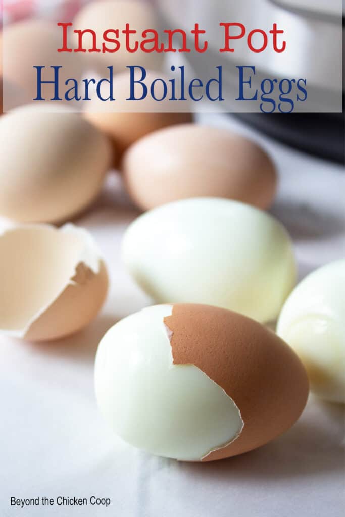 Hard boiled eggs with part of the peel off the egg.
