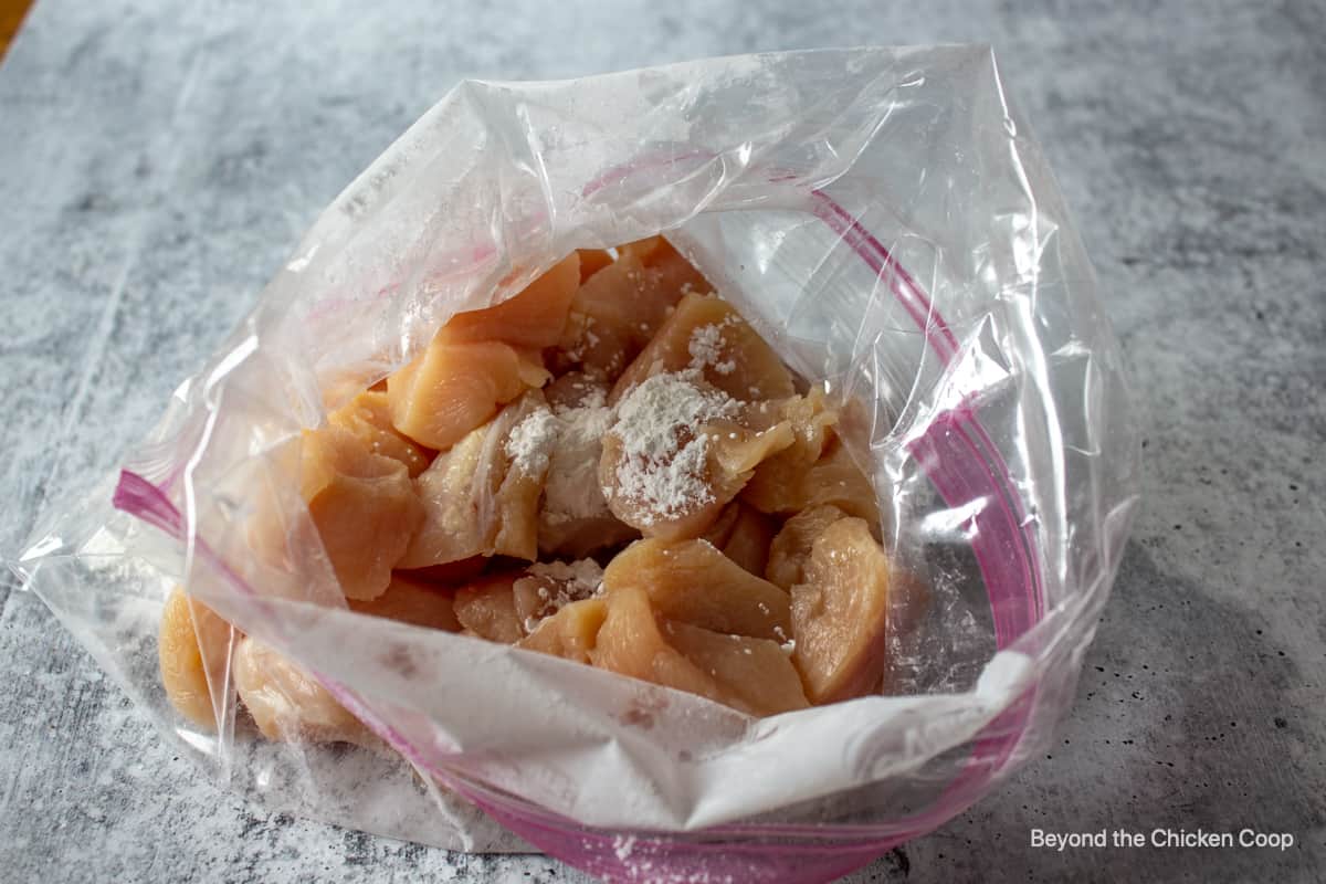 Cut chicken in a plastic bag.