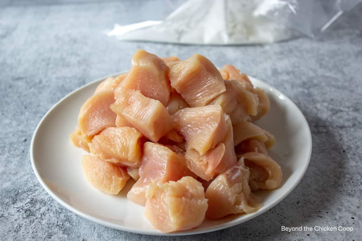 Raw chicken cut up into small cubes.