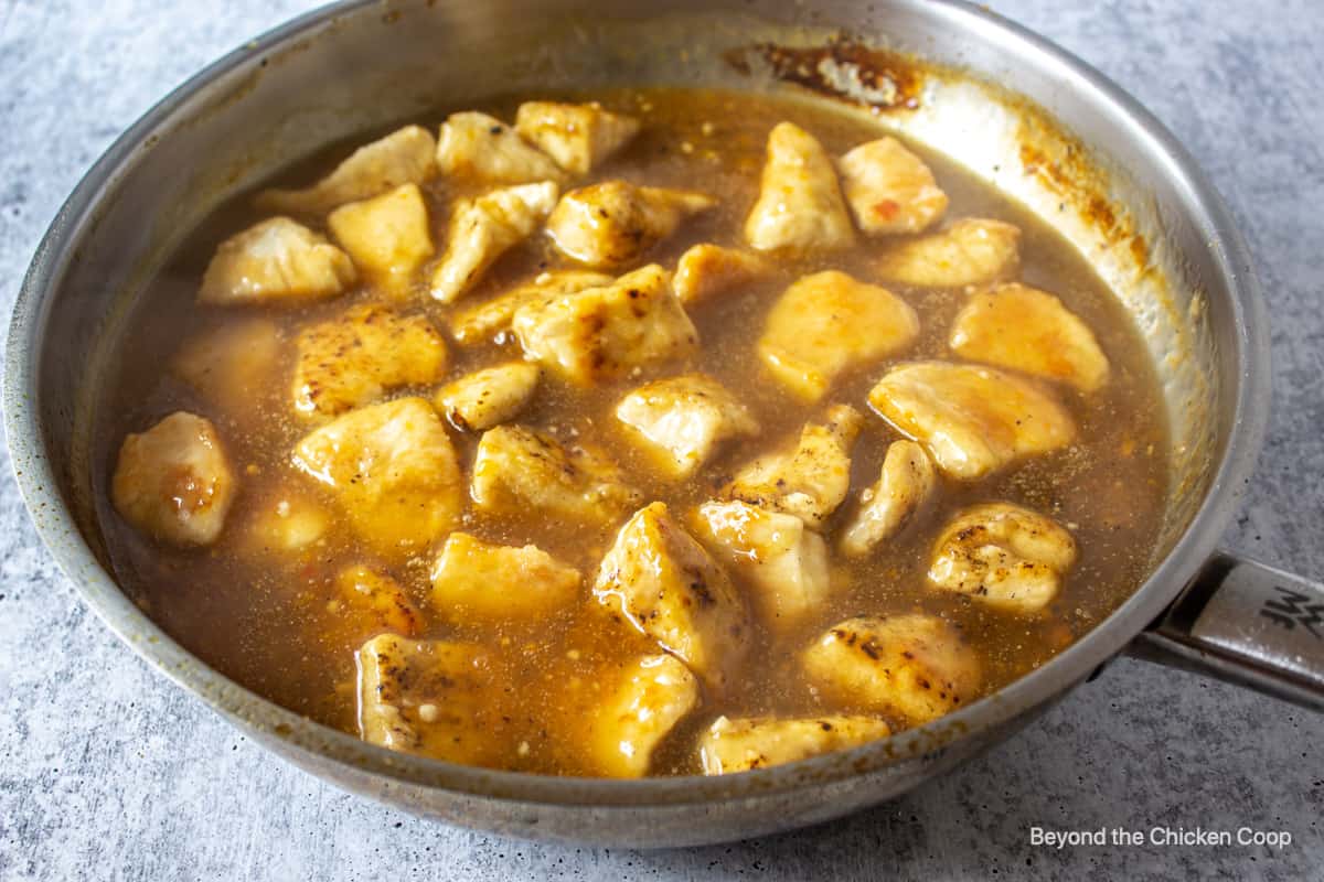 Orange chicken in a fry pan.