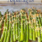 A cookie sheet lined with asparagus.