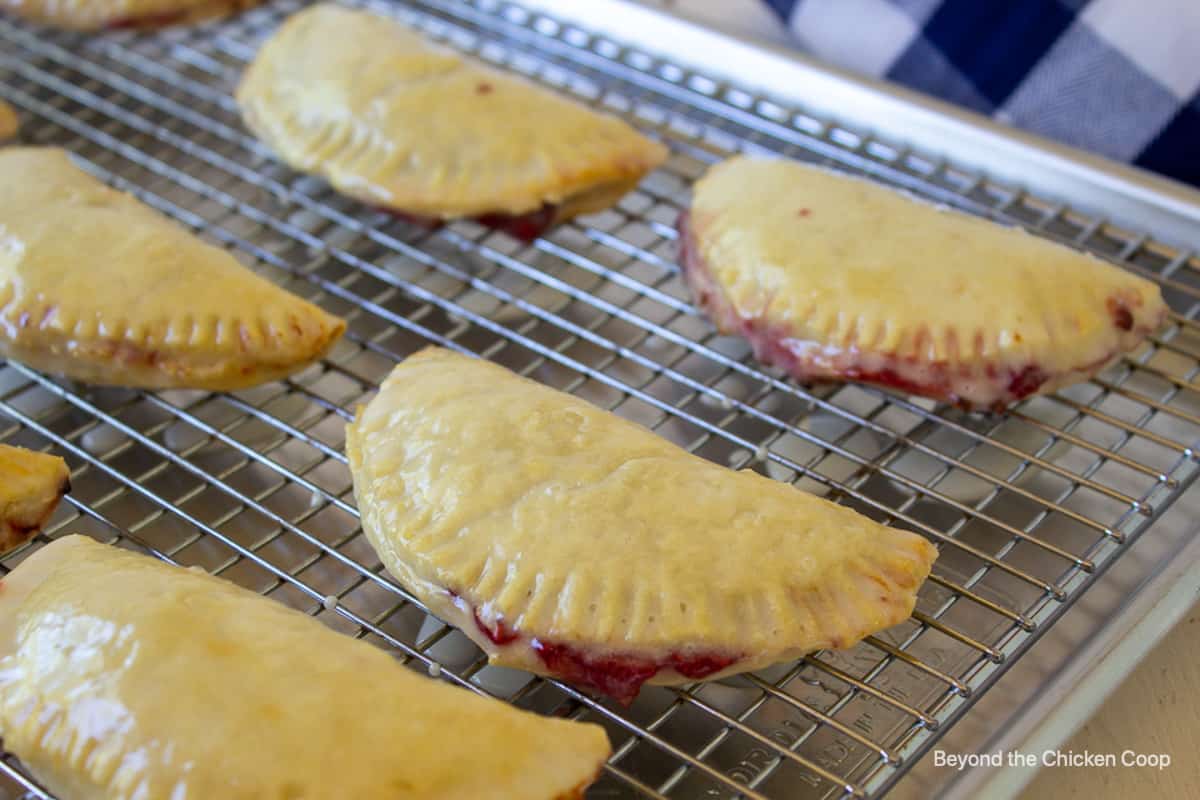 Small pies on a baking rack.