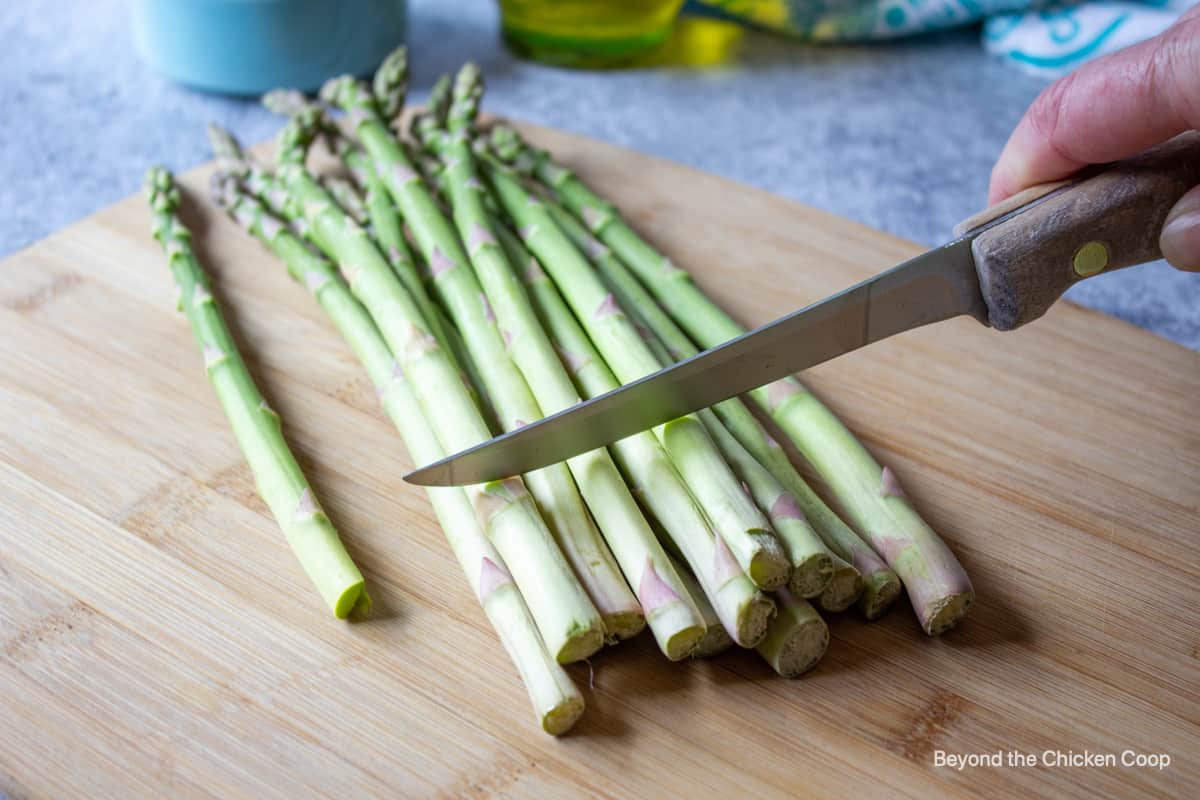 Cutting a bunch of asparagus.