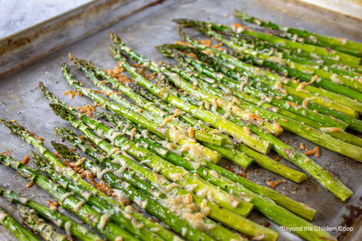 Oven roasted asparagus on a baking sheet.