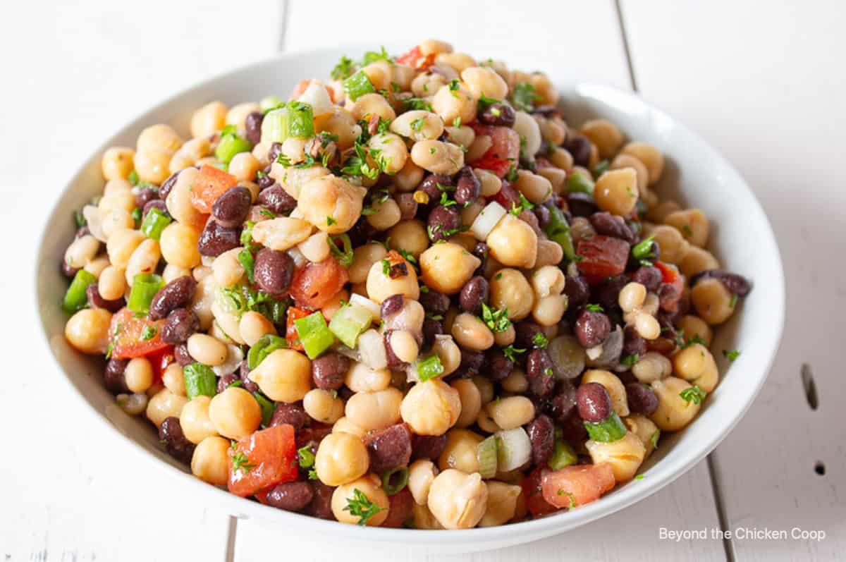 A three bean salad in a white bowl.