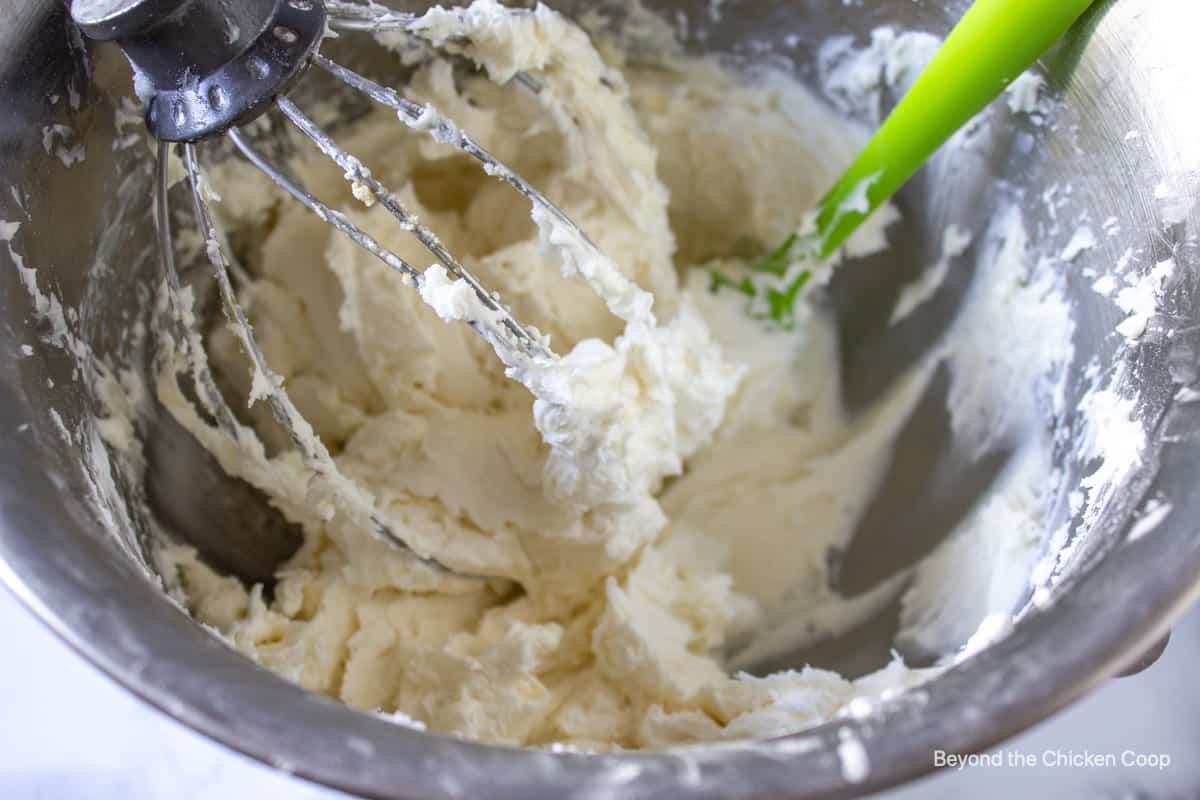 Buttercream icing in a metal mixing bowl.