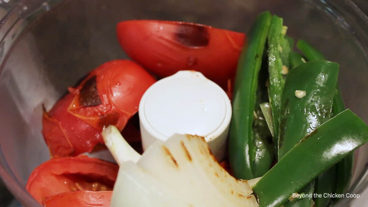 Tomatoes, onions and peppers in a food processor.