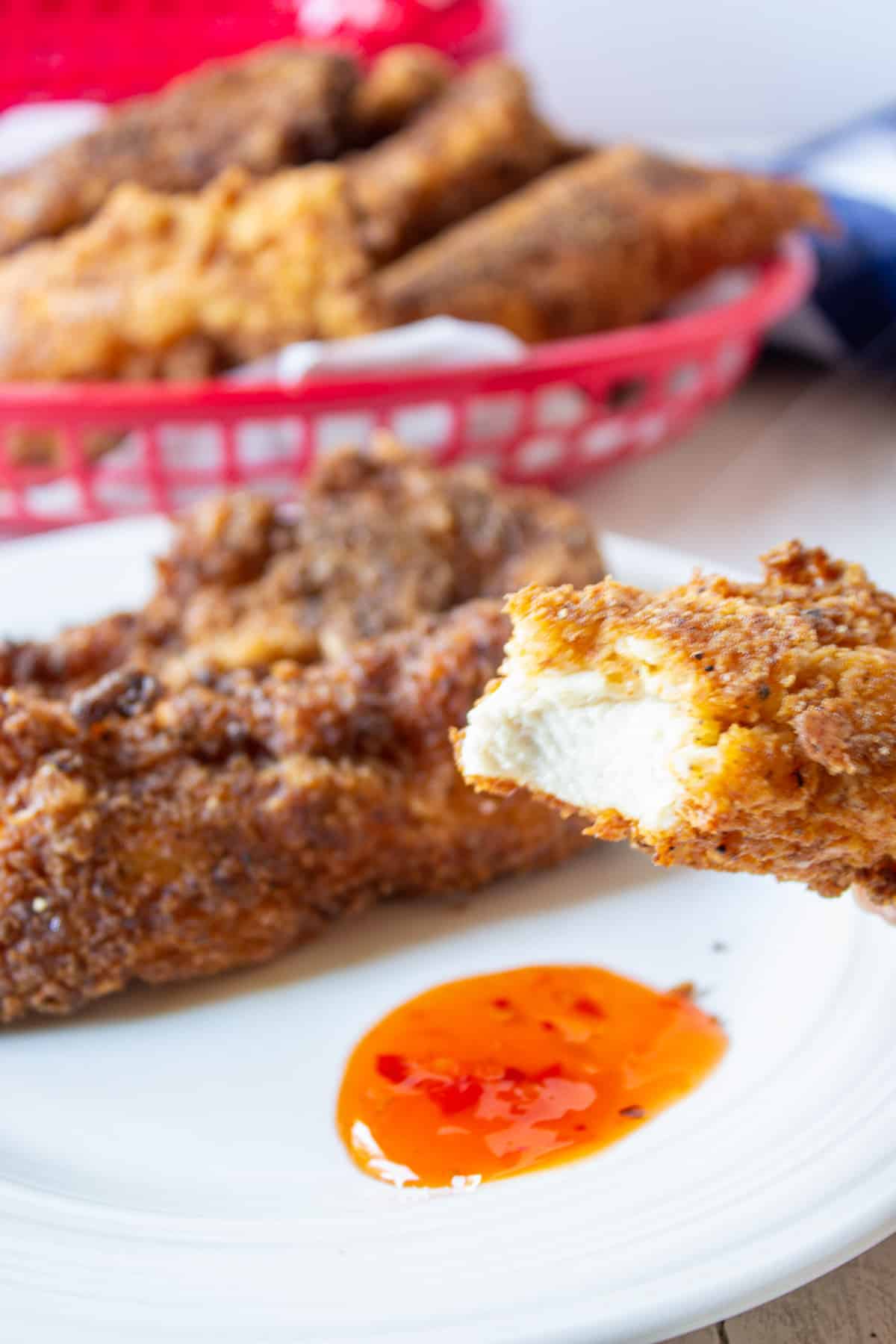 A chicken strip with a bite out of one end.
