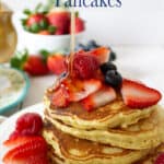 A stack of pancakes topped with fresh berries.