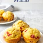 Muffins with strawberries on a white plate.