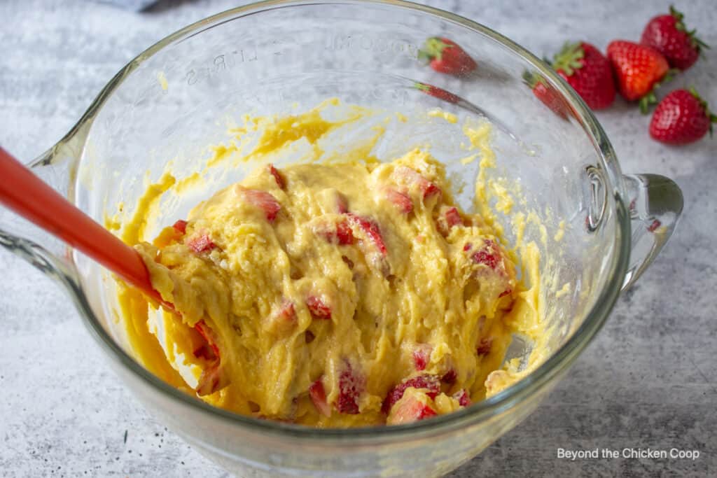 Mixed muffin batter in a glass bowl.