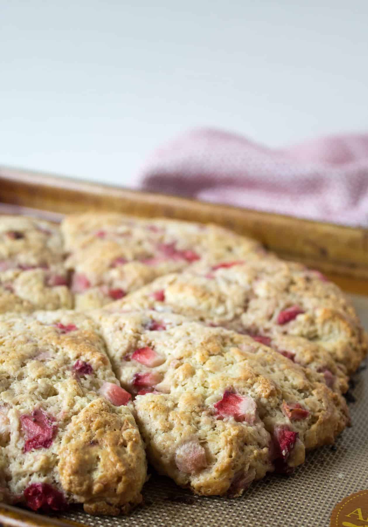 A baking sheet with baked strawberry scones.