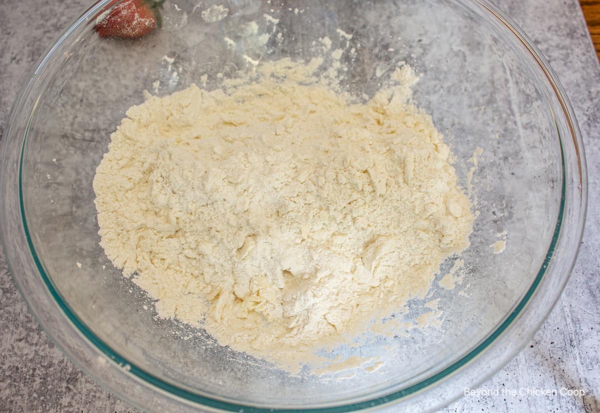 A glass bowl filled with flour.