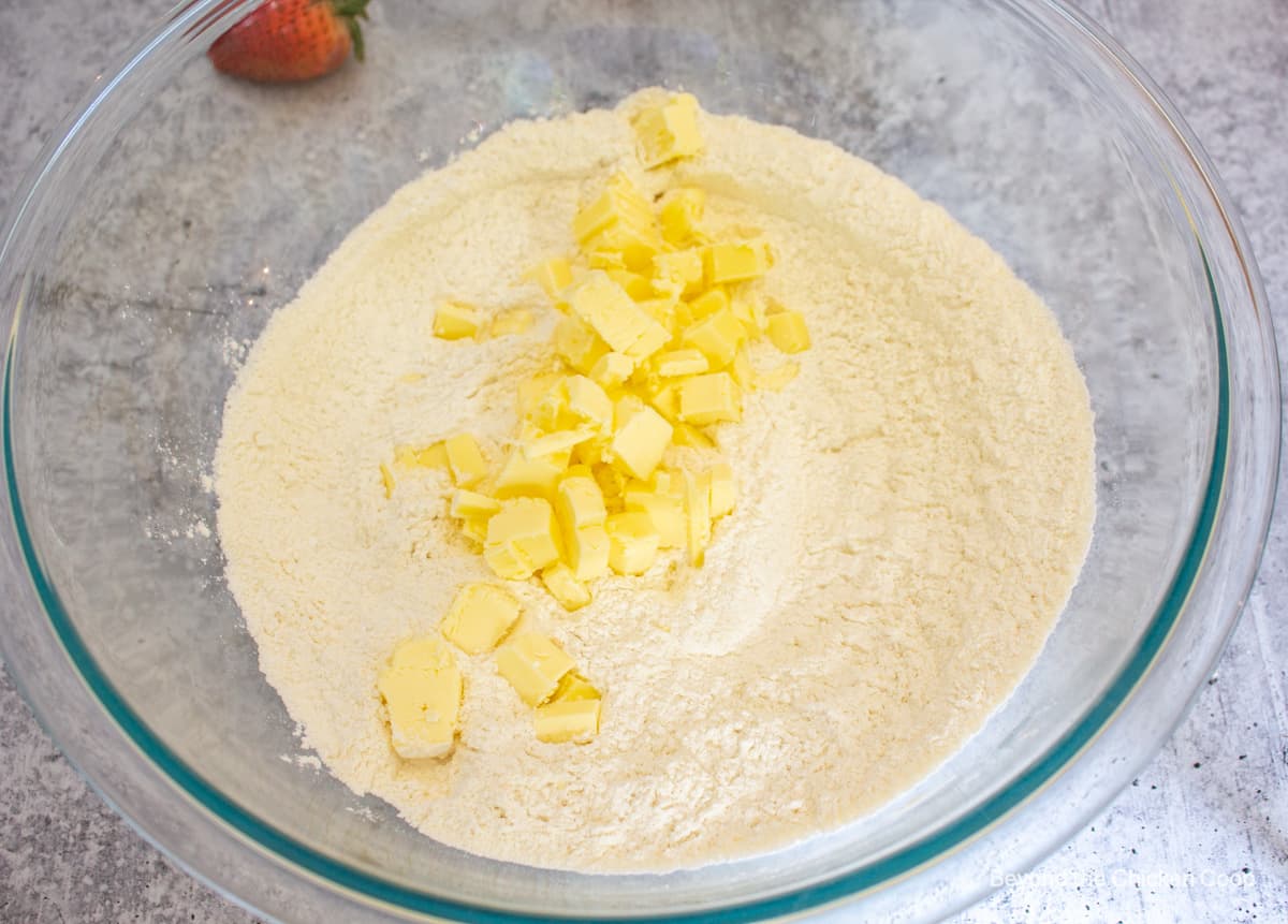 Small cubes of butter on top of a flour mixture.