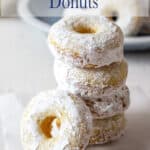 A stack of powdered sugar donuts.