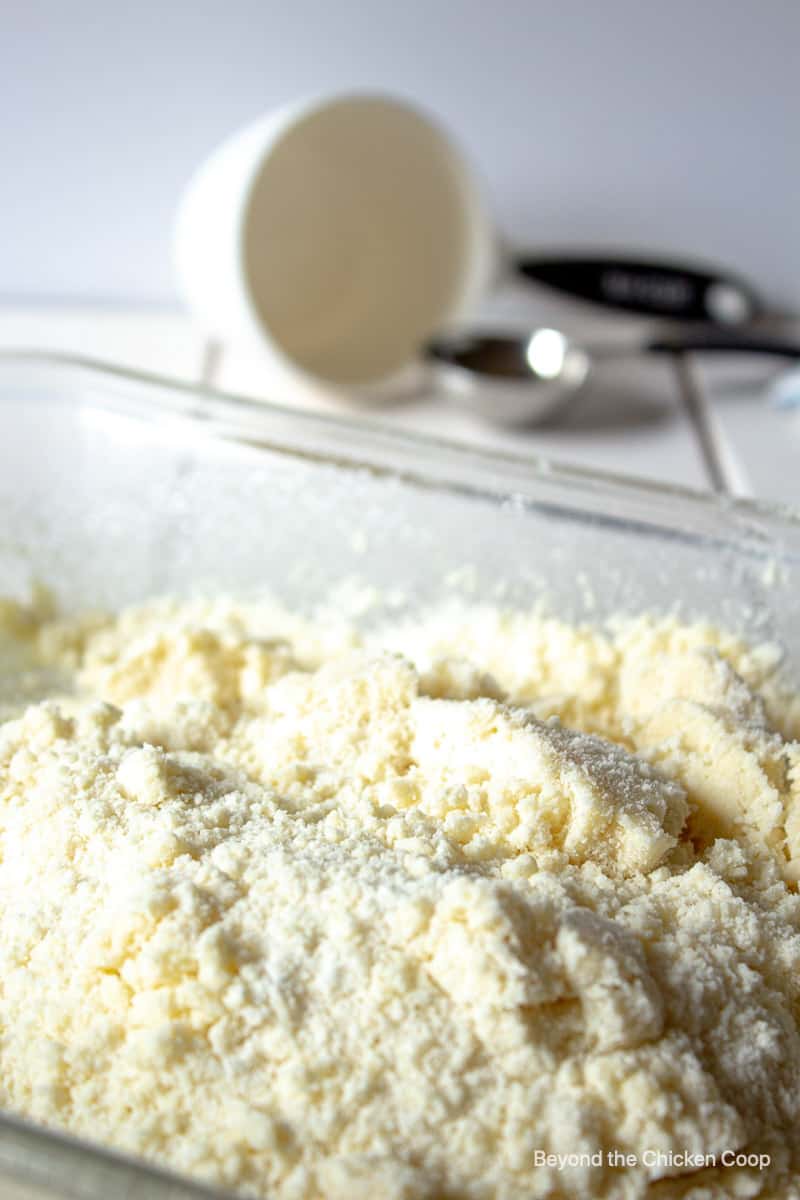 A baking dish filled with a flour mixture.