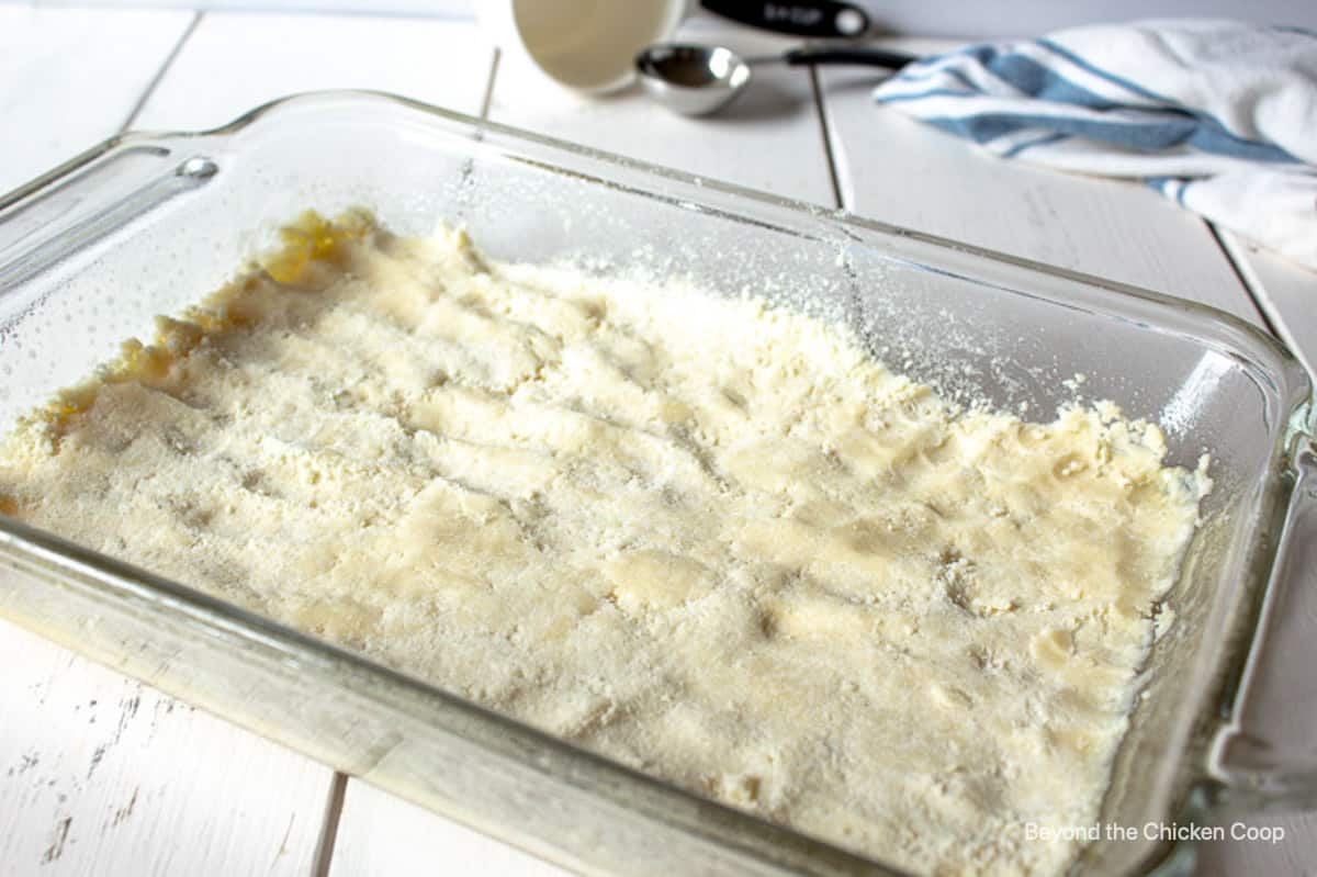 Pressed unbaked crust in a glass baking dish.