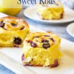 Sweet rolls filled with blueberries on a white platter.
