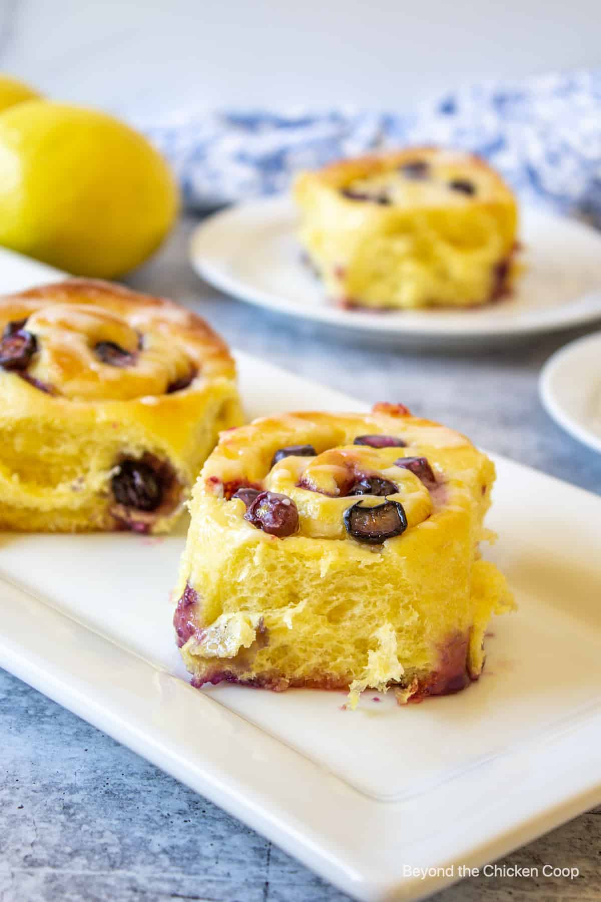 Blueberry sweet rolls on a white platter.