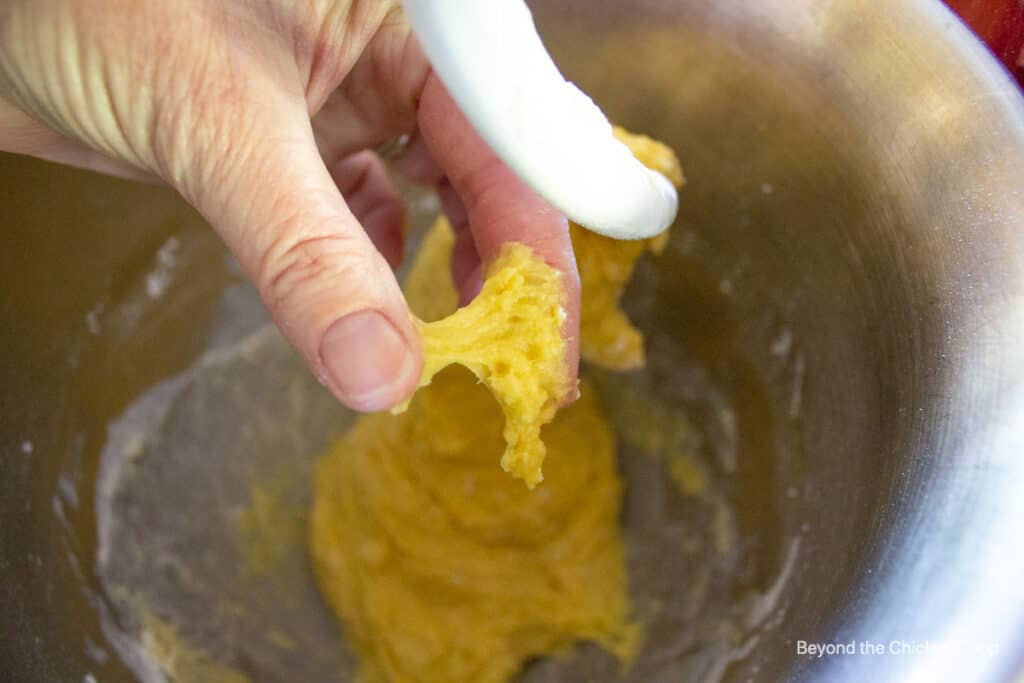 Sticky dough stuck to two fingers.