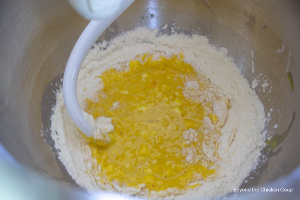 Flour and egg mixture in a stand mixer bowl.