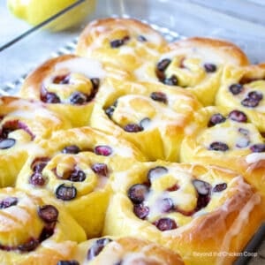 A pan filled with blueberry sweet rolls.