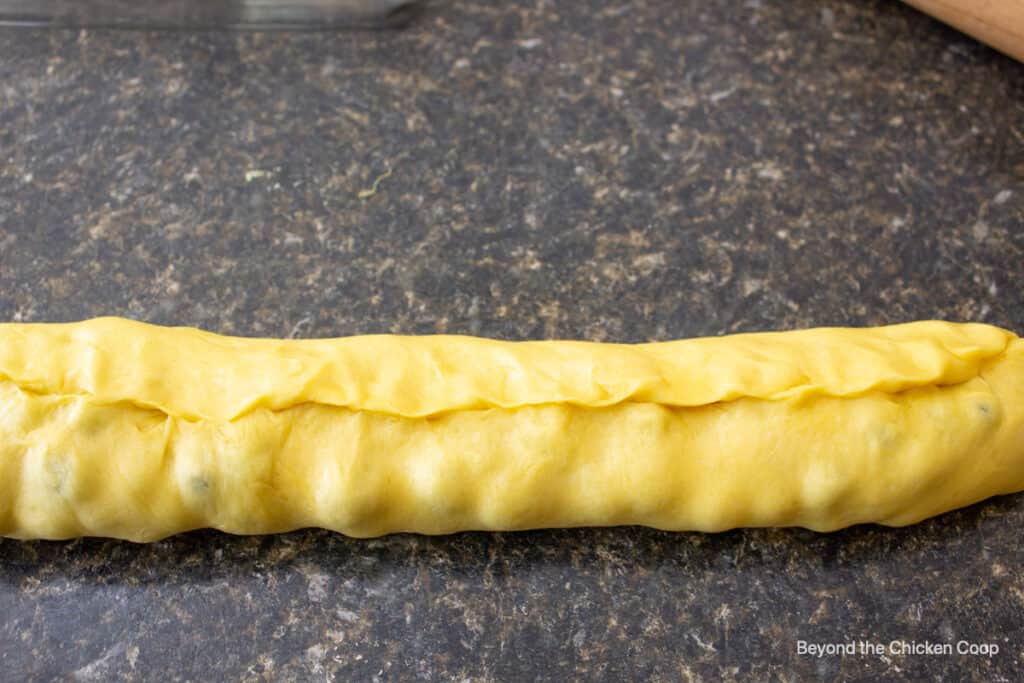 A roll of dough with the ends pinched together.