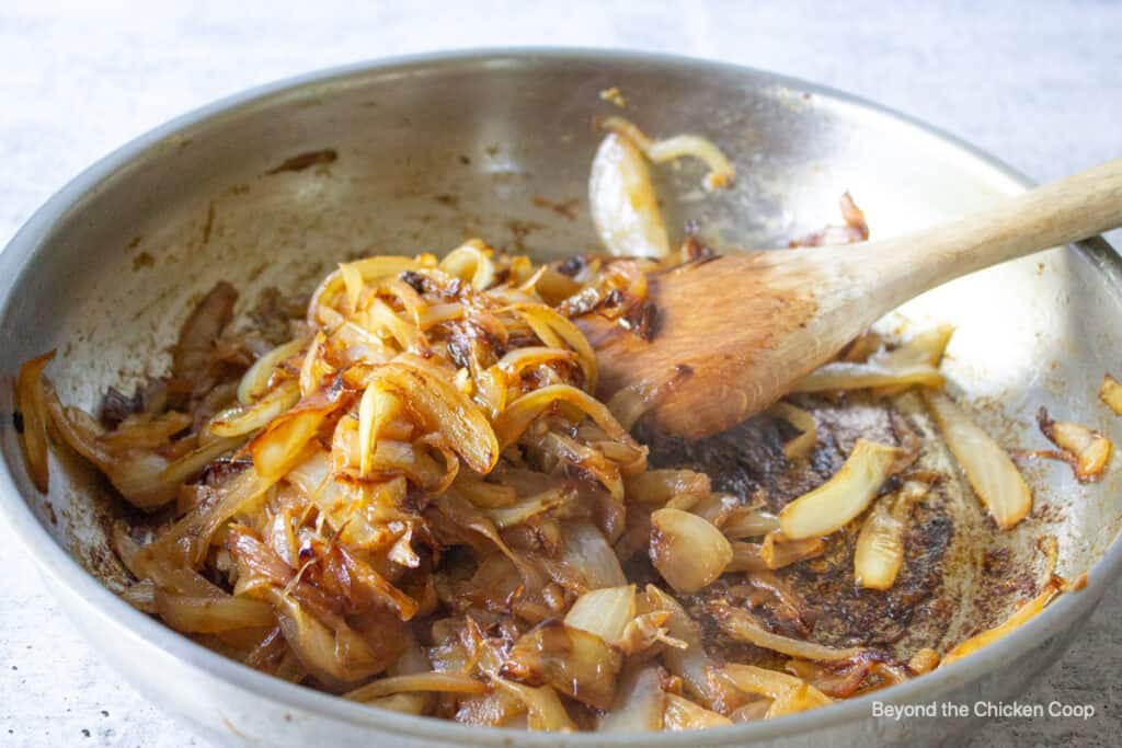 Onions cooking in a pan.