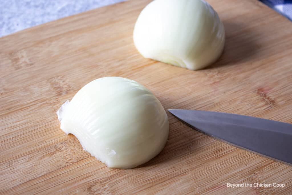 A half of an onion on a cutting board.