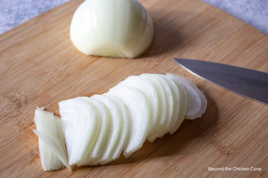 Sliced onions on a cutting board.