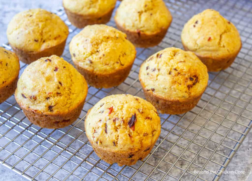 Baked muffins on a cooling rack.
