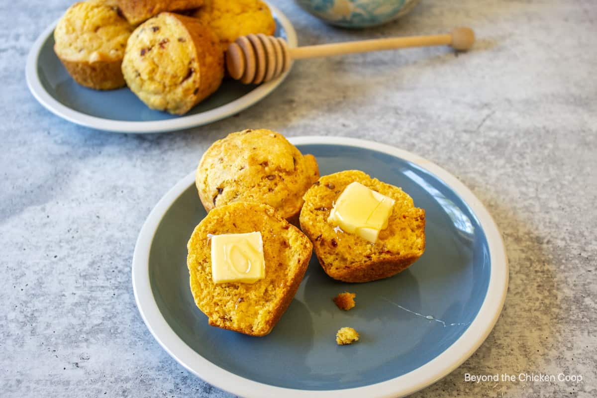 Chipotle Muffins cut in half and topped with butter and honey.