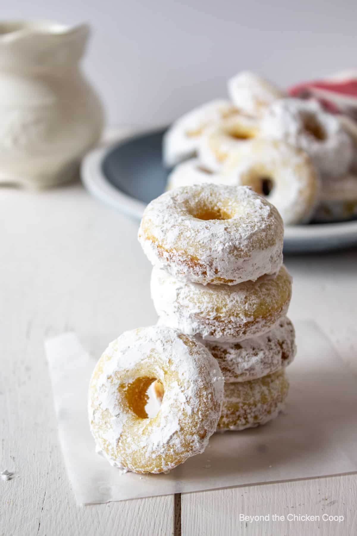 A stack of powdered sugar mini donuts.