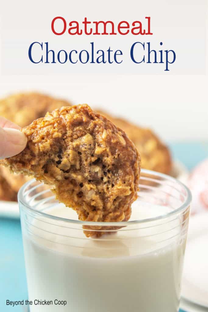 A cookie dipping into a glass of milk.