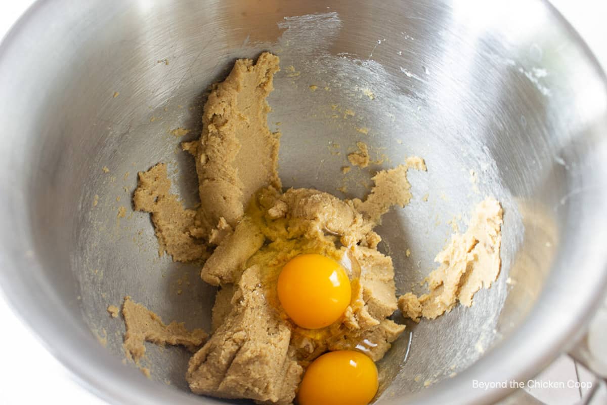 Eggs in a mixing bowl with cookie batter.