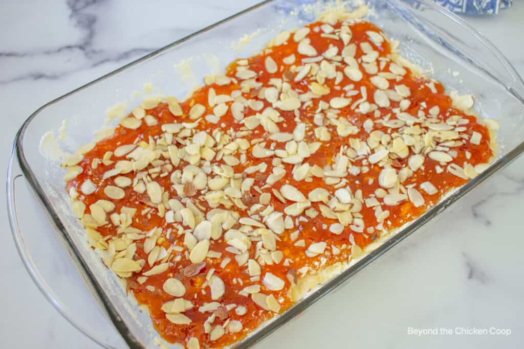 Almond slices over the top of apricot bars.