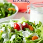 A green salad with a creamy salad dressing.