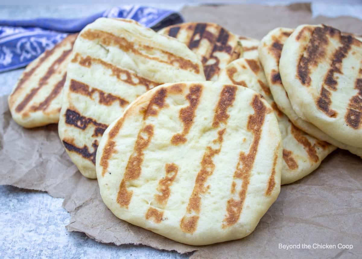 Grilled flatbread on a brown piece of paper.