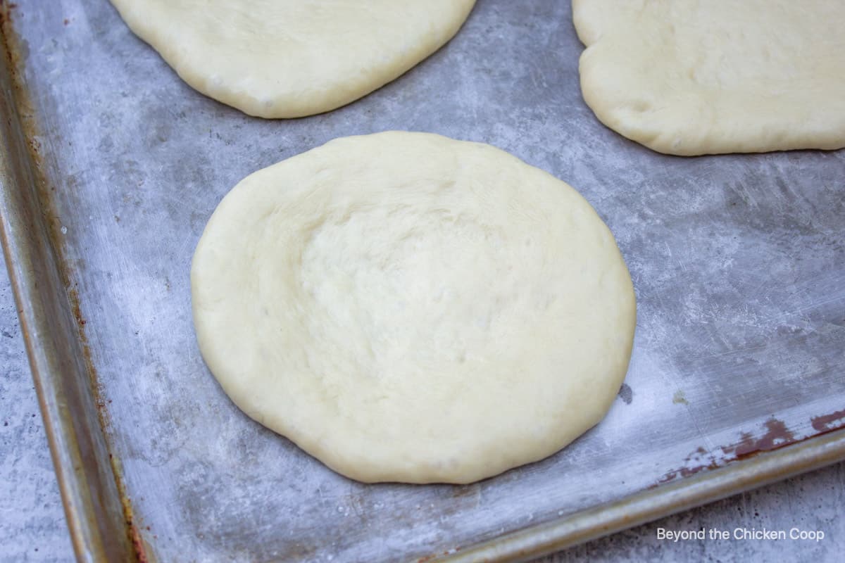 Flatbread dough on a baking sheet.