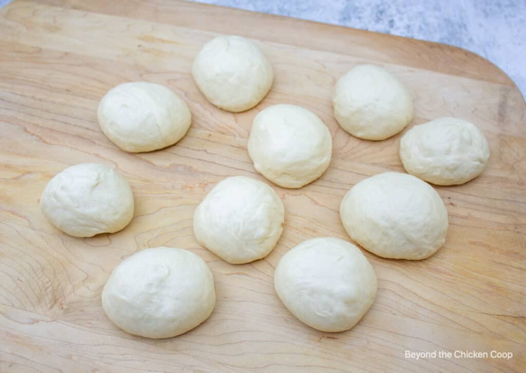 Balls of dough on a wooden board.