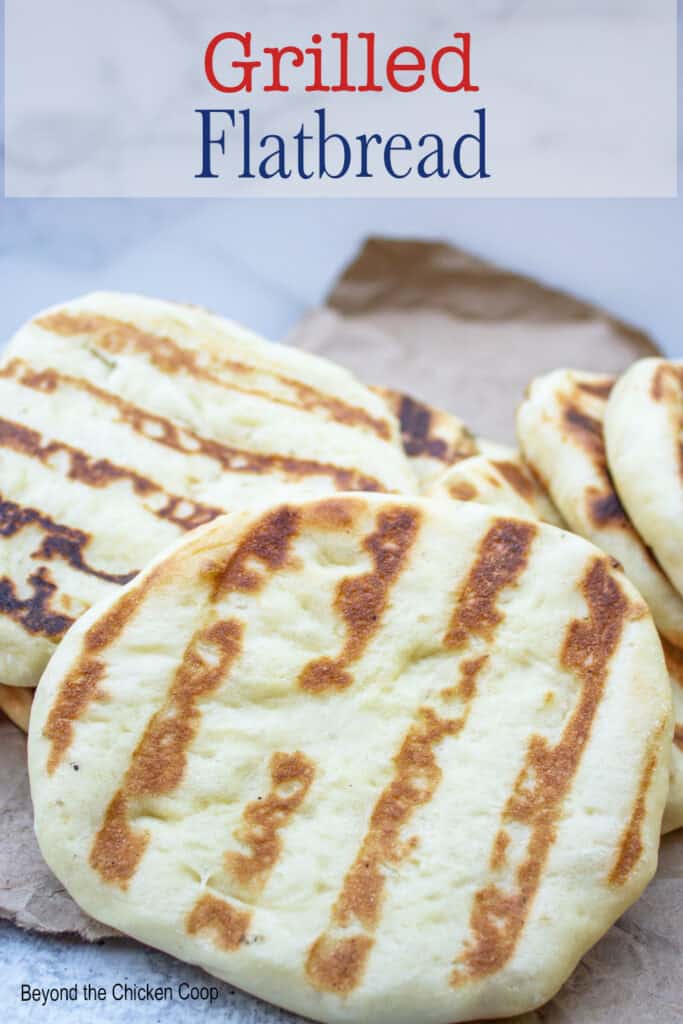 A pile of flatbreads on a brown paper.