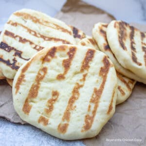 Flatbread rounds on a brown paper bag.