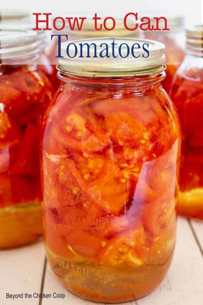 A canning jar filled with chopped tomatoes.